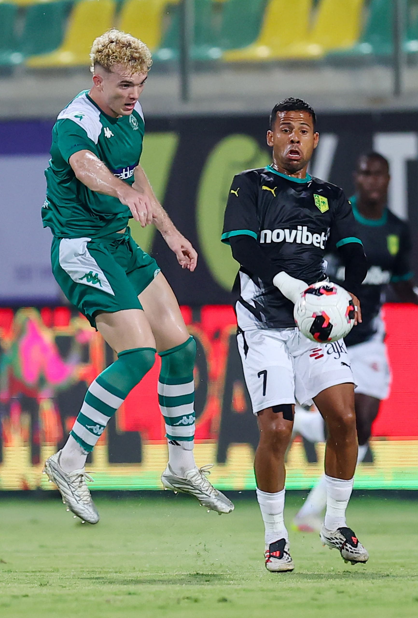 Fergus Tierney rising for a header in the Omonia29 kit